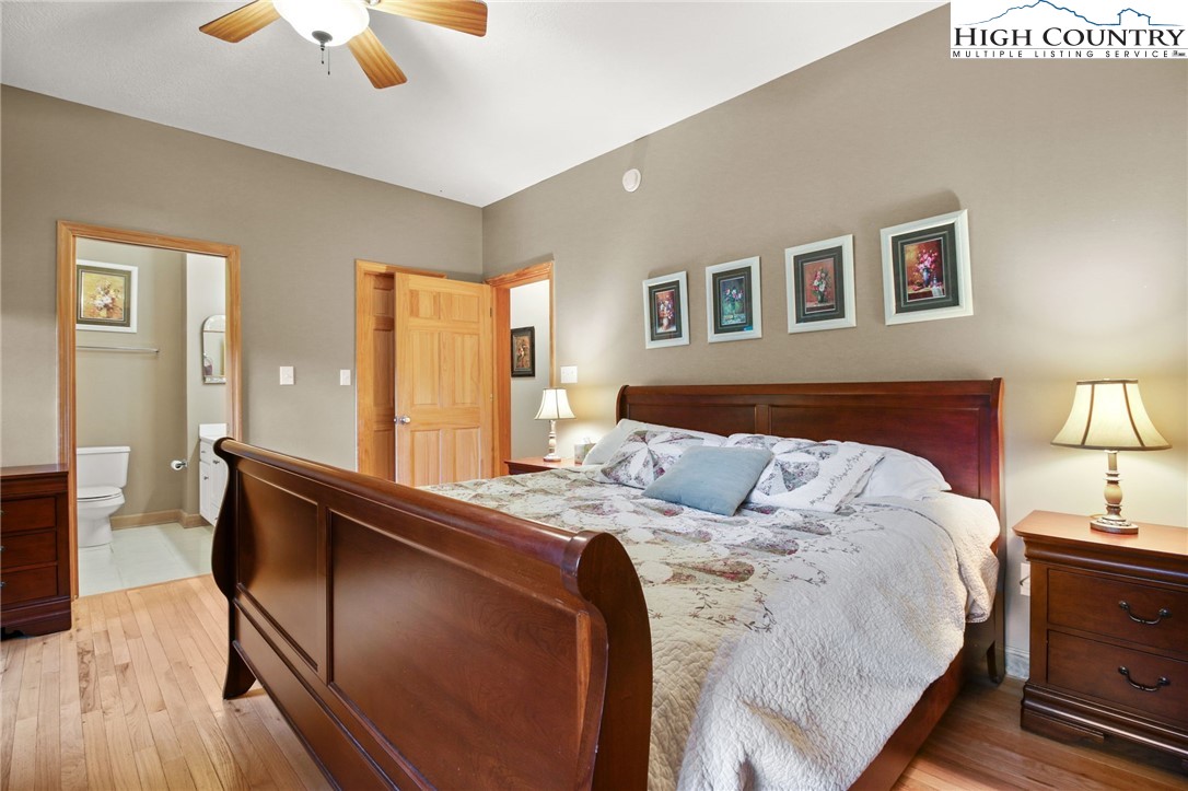 105 Old Field Road Beech Mountain, NC 28604 - Photo 31 of 43 a bed room with a bed and a lamp