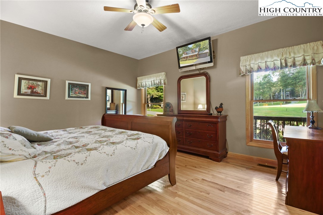 105 Old Field Road Beech Mountain, NC 28604 - Photo 32 of 43 a bedroom with a bed and wooden floor