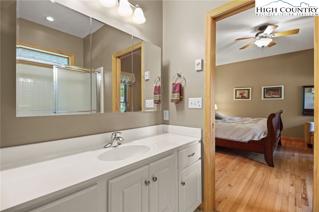 105 Old Field Road Beech Mountain, NC 28604 - Photo 33 of 43 a en suite bathroom with a sink and a mirror