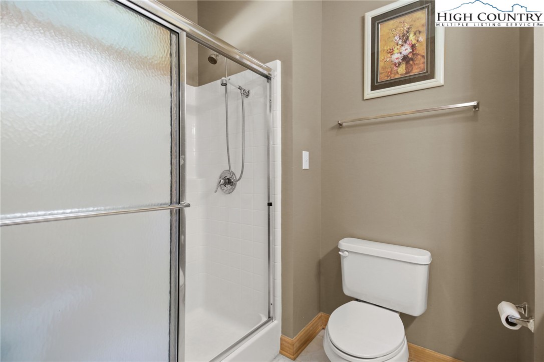 105 Old Field Road Beech Mountain, NC 28604 - Photo 34 of 43 a white toilet sitting next to a shower