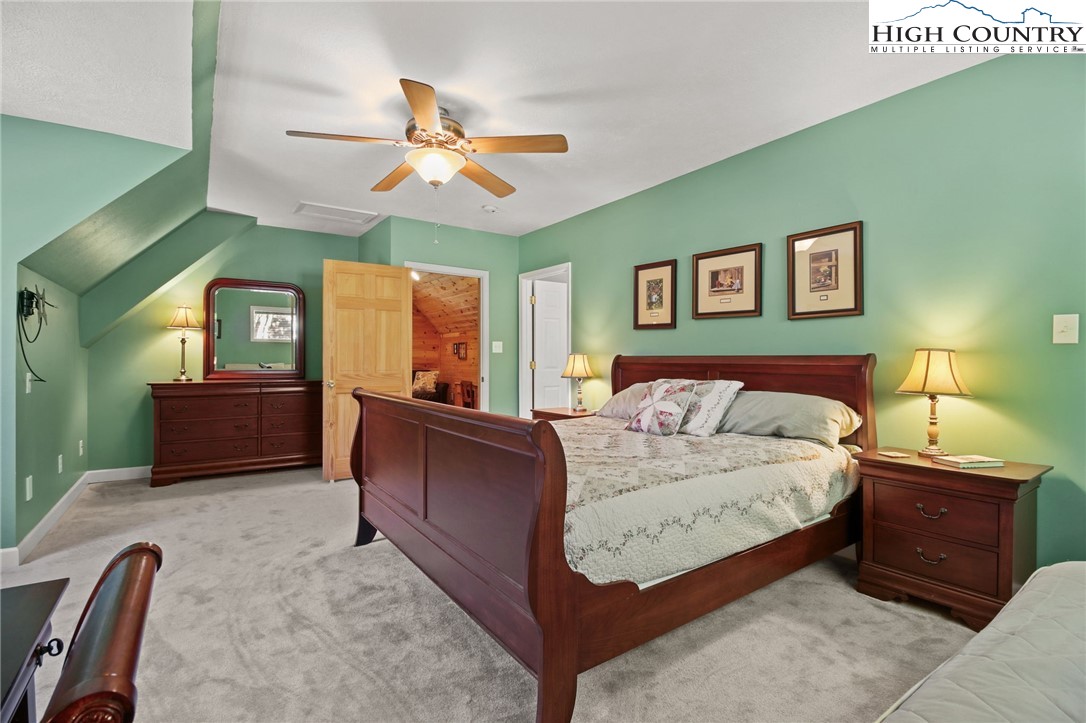 105 Old Field Road Beech Mountain, NC 28604 - Photo 37 of 43 a bedroom with a bed and window