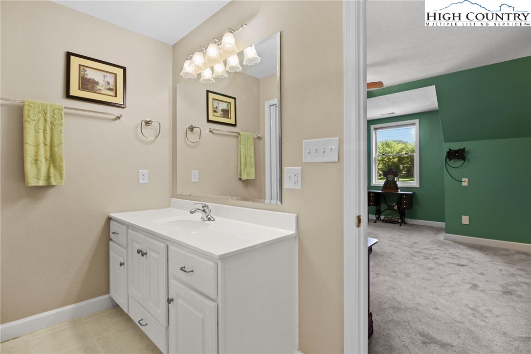 105 Old Field Road Beech Mountain, NC 28604 - Photo 39 of 43 a spacious bathroom with a sink and a mirror