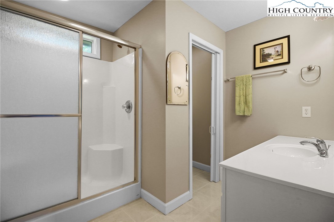 105 Old Field Road Beech Mountain, NC 28604 - Photo 40 of 43 a bathroom with a shower and a sink