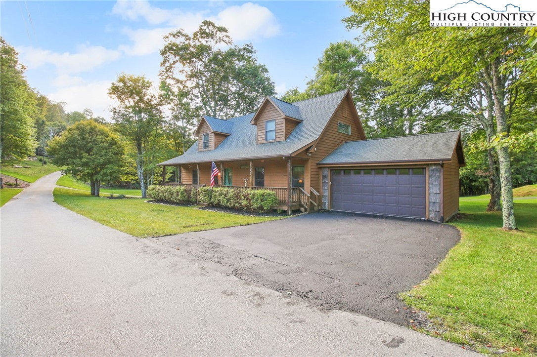 105 Old Field Road Beech Mountain, NC 28604 - Photo 5 of 43 a view of a house with a yard and large tree