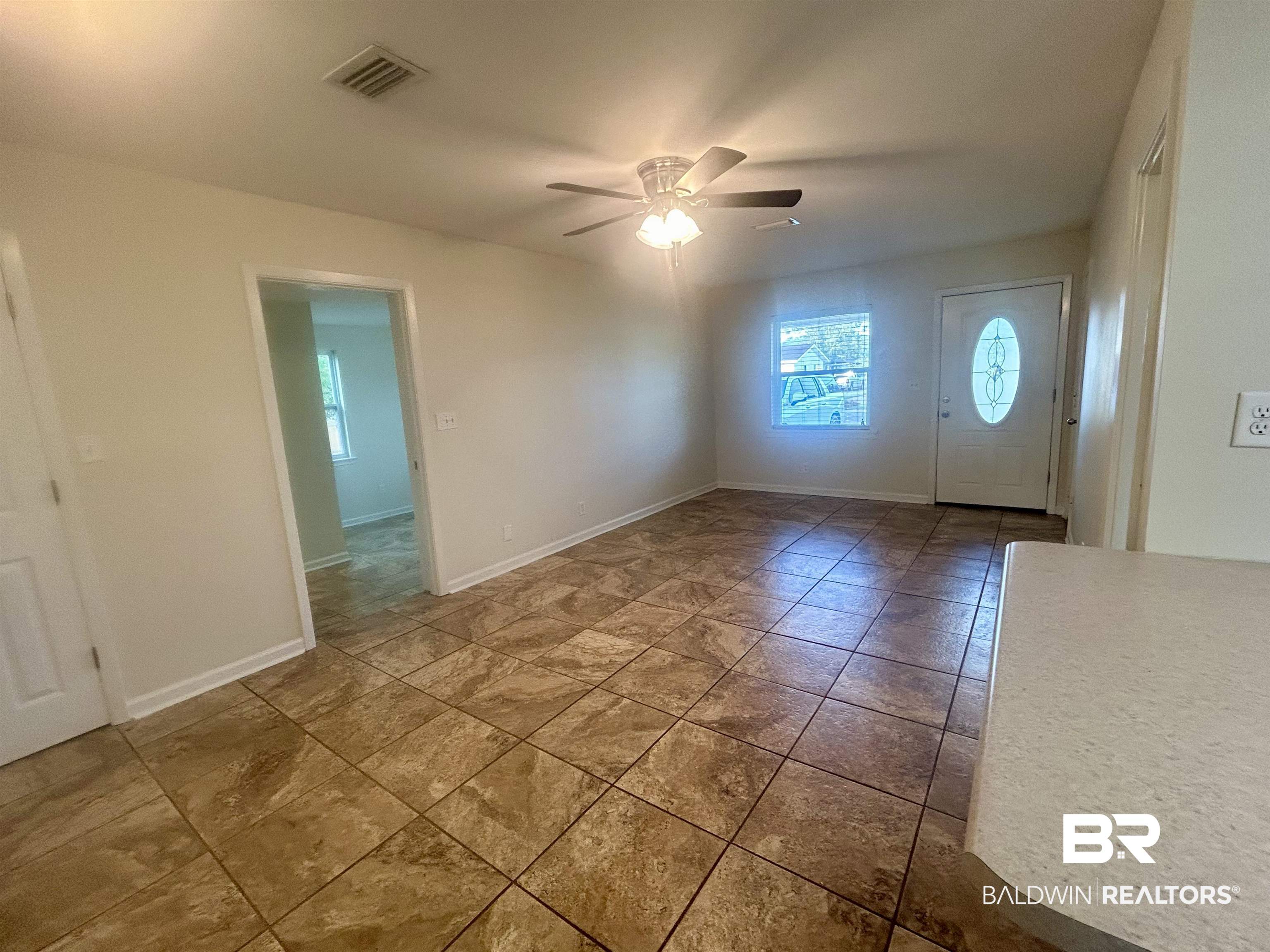 187 Van Hoosen Road Flomaton, AL 36441 - Photo 6 of 29 Unfurnished room featuring ceiling fan and baseboards