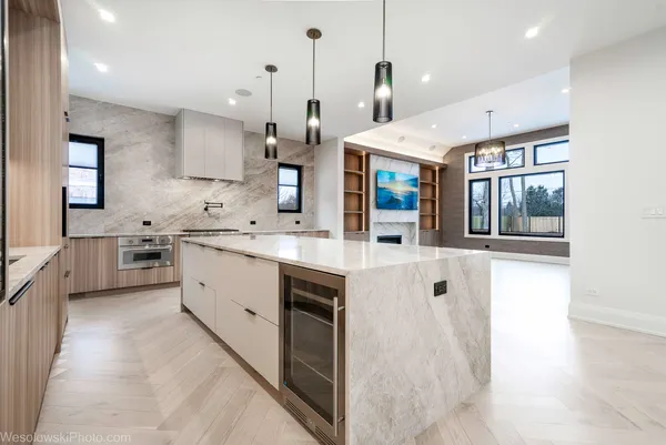 a view of a livingroom with a fireplace a flat screen tv and kitchen view