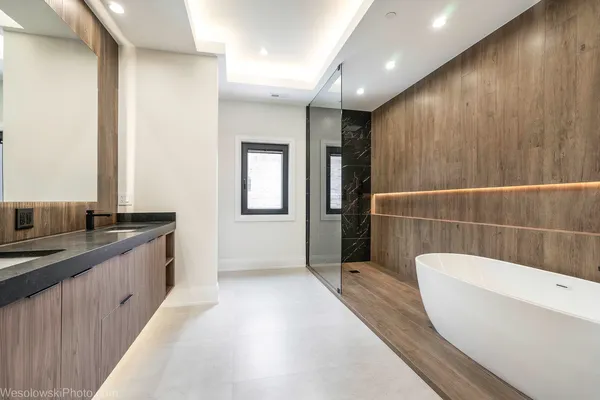 a view of an empty room with wooden floor and closet