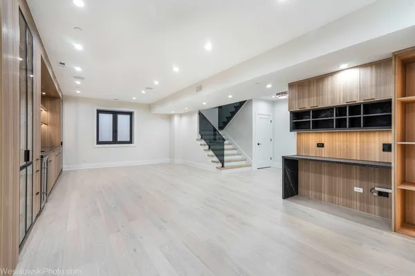 an empty room with a cabinet and mirror