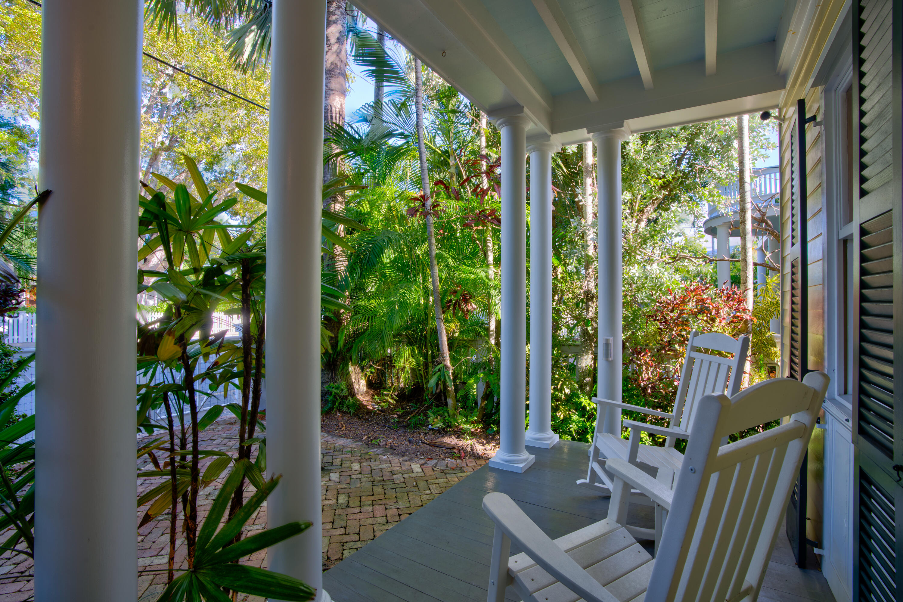 1416 White Street Key West, FL 33040 - Photo 47 of 61 a porch with chairs and wooden floor