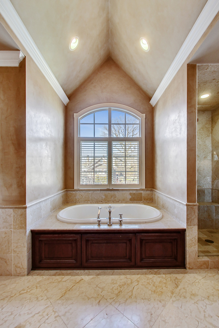 772 Walden Road Winnetka, IL 60093 - Photo 26 of 55 a spacious bathroom with a tub and large window