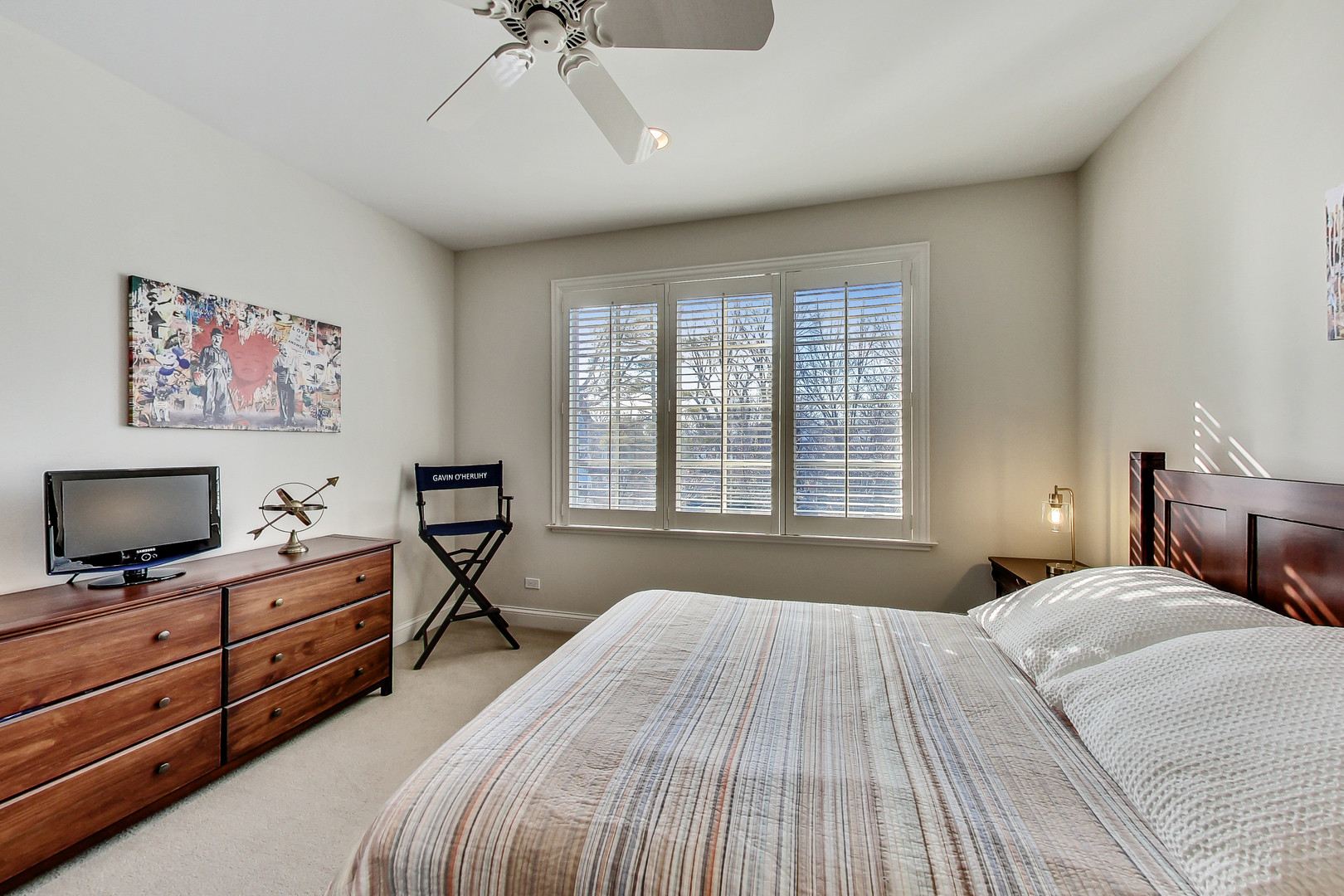 772 Walden Road Winnetka, IL 60093 - Photo 32 of 55 a bedroom with a bed and a flat tv screen on dresser