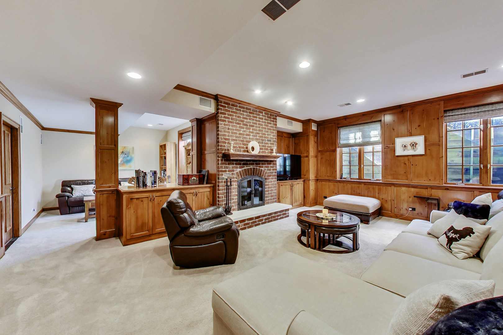772 Walden Road Winnetka, IL 60093 - Photo 36 of 55 a living room with furniture gym equipment and a fireplace