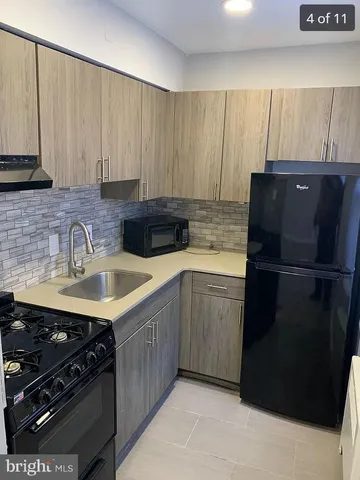 a kitchen with a sink stove and refrigerator