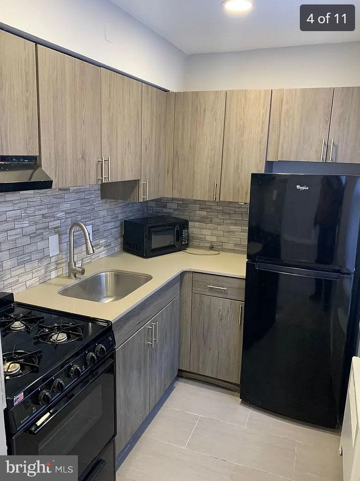 a kitchen with a sink stove and refrigerator