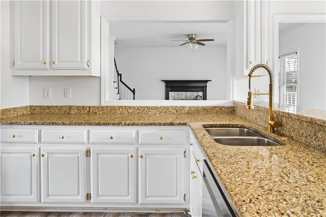a kitchen with granite countertop a sink and dishwasher