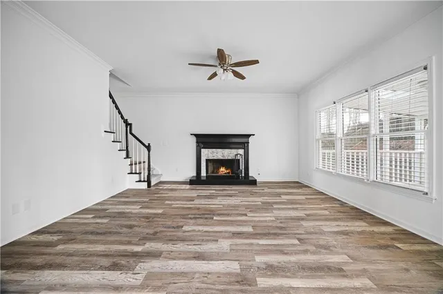 a view of an empty room with a fireplace and a window