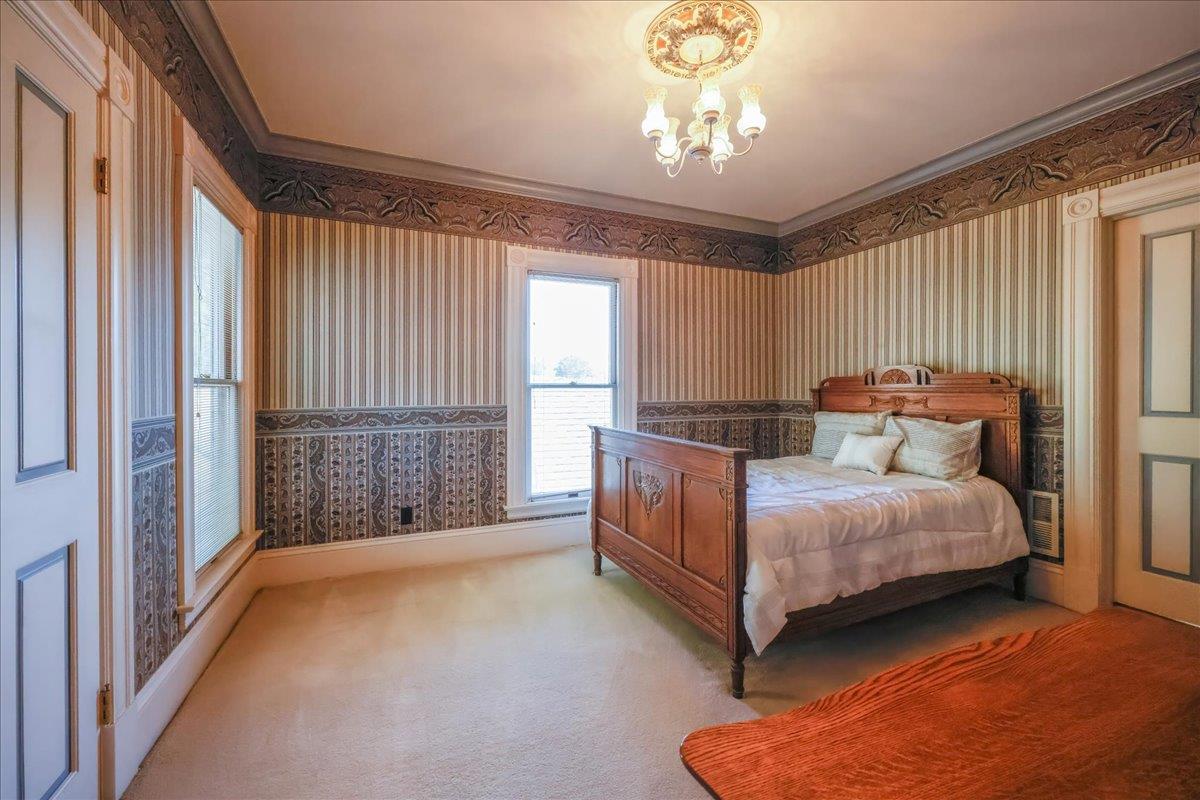 1167 Settle Avenue San Jose, CA 95125 - Photo 19 of 35 a bed room with a bed and a chandelier