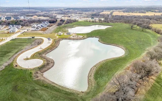 swimming pool view with a lake view