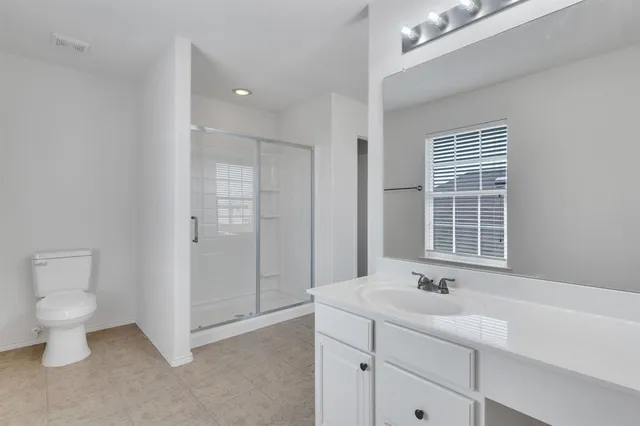 a bathroom with a toilet sink and shower