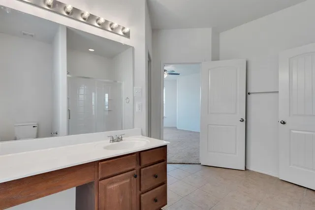 a bathroom with a sink double vanity and a mirror
