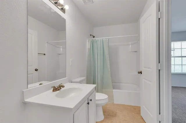 a bathroom with a sink toilet tub and shower