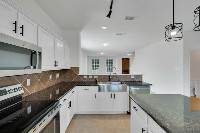 a kitchen that has a sink and a stove