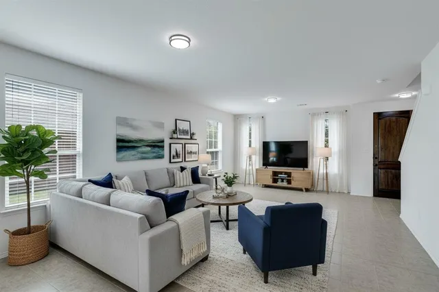 a living room with furniture and a flat screen tv