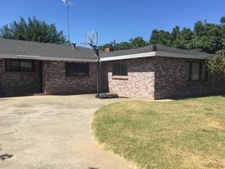 2077 Larkin Road Biggs, CA 95917 - Photo 4 of 11 a front view of a house with a yard