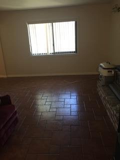 2077 Larkin Road Biggs, CA 95917 - Photo 8 of 11 a view of empty room with window and fireplace