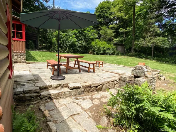a view of a houses with snow on the road