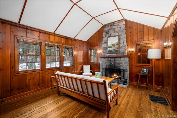 a view of a living room with furniture fireplace and windows
