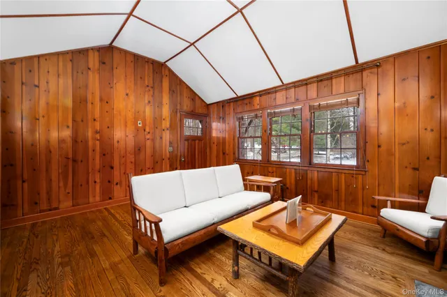 a living room with furniture a table and wooden floor