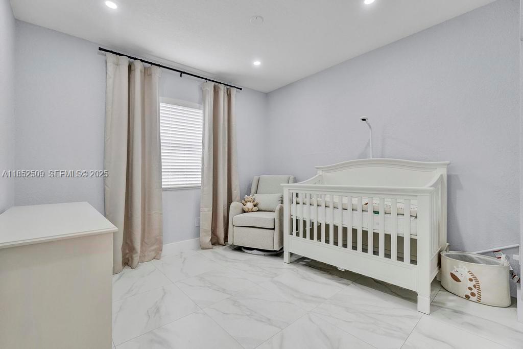 6470 Southwest 27th Street Miami, FL 33155 - Photo 16 of 38 a bedroom with a bed and a window