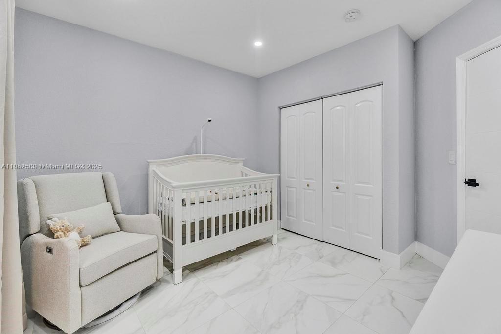 6470 Southwest 27th Street Miami, FL 33155 - Photo 17 of 38 a bedroom with furniture and a ceiling fan