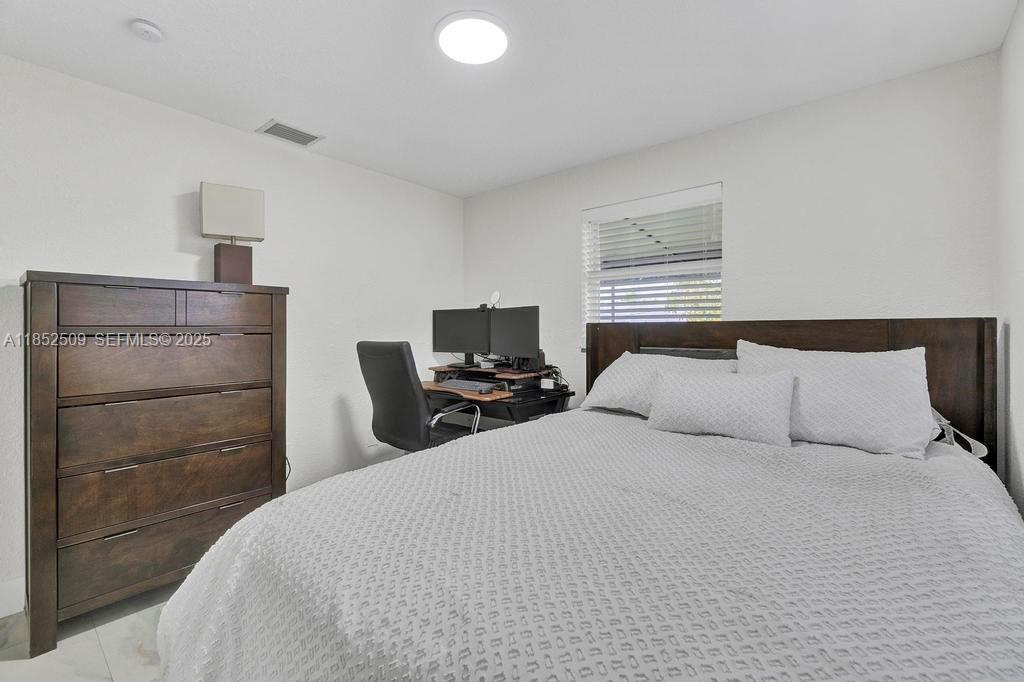 6470 Southwest 27th Street Miami, FL 33155 - Photo 19 of 38 a bedroom with a bed and a television