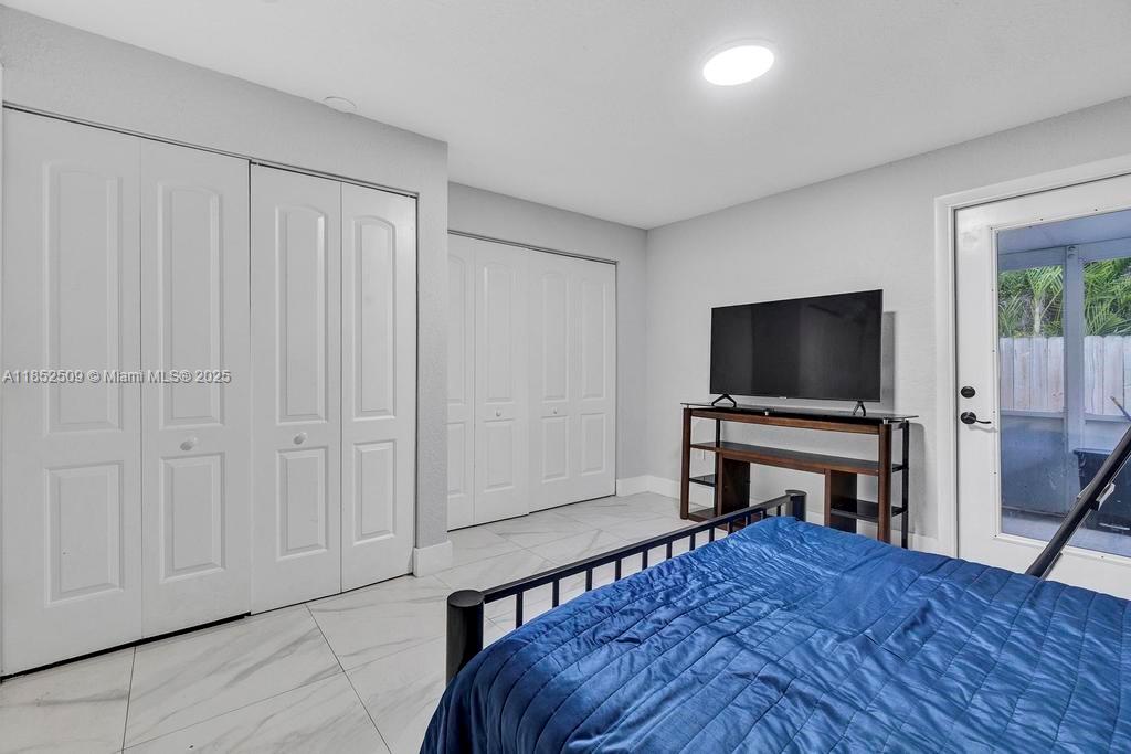 6470 Southwest 27th Street Miami, FL 33155 - Photo 21 of 38 a living room with furniture and a flat screen tv