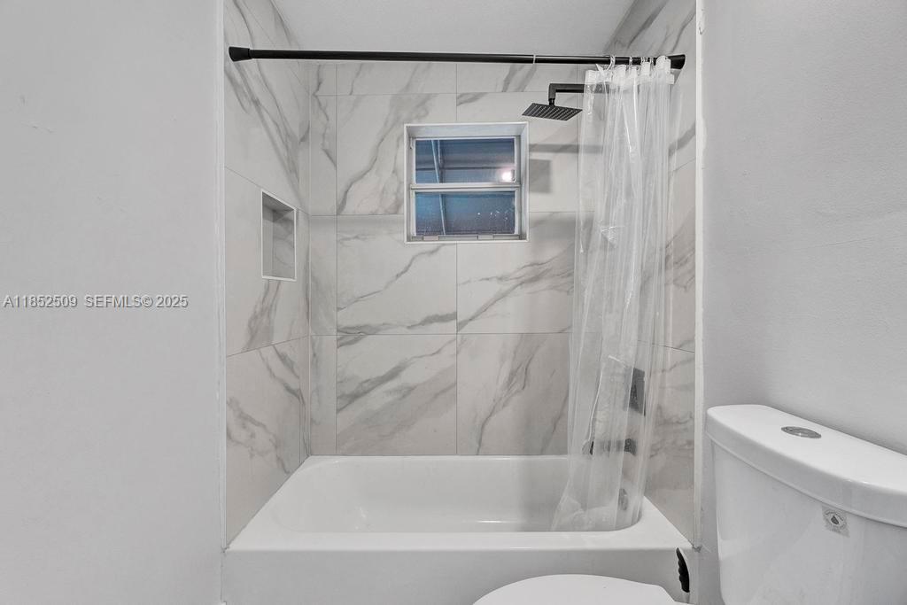 6470 Southwest 27th Street Miami, FL 33155 - Photo 23 of 38 a bathroom with a shower and a toilet