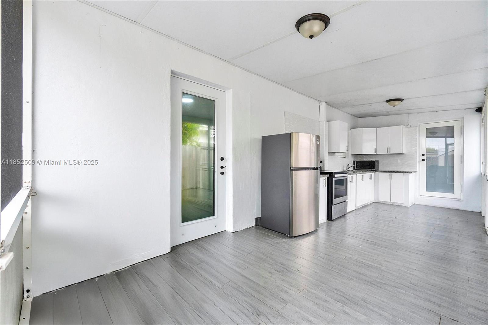 6470 Southwest 27th Street Miami, FL 33155 - Photo 30 of 38 a view of kitchen refrigerator and wooden floor