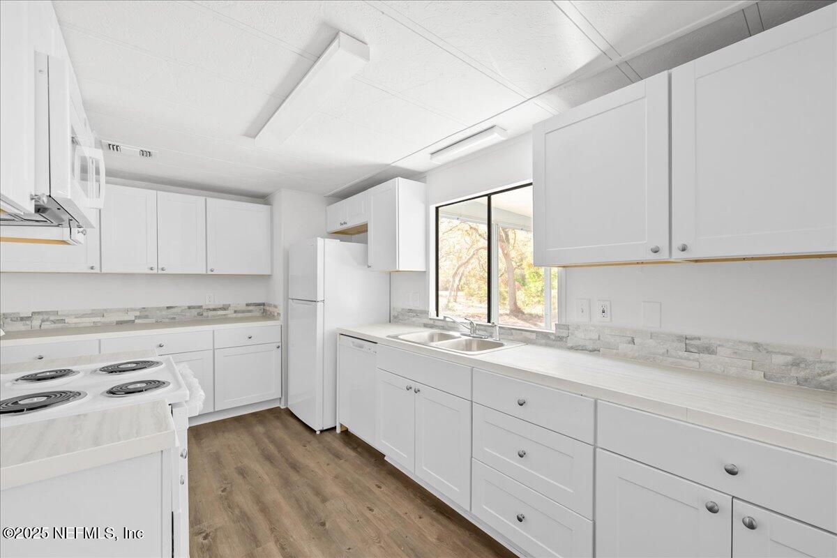 112 Bayberry Road Georgetown, FL 32139 - Photo 18 of 44 a kitchen with cabinets appliances a sink and a window