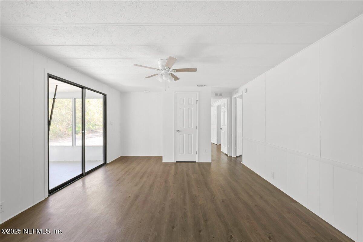 112 Bayberry Road Georgetown, FL 32139 - Photo 22 of 44 a view of an empty room with a window and wooden floor