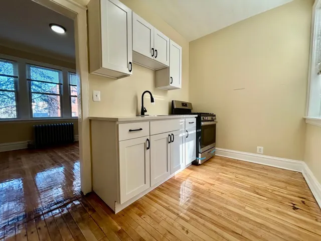 a kitchen with stainless steel appliances a sink and cabinets