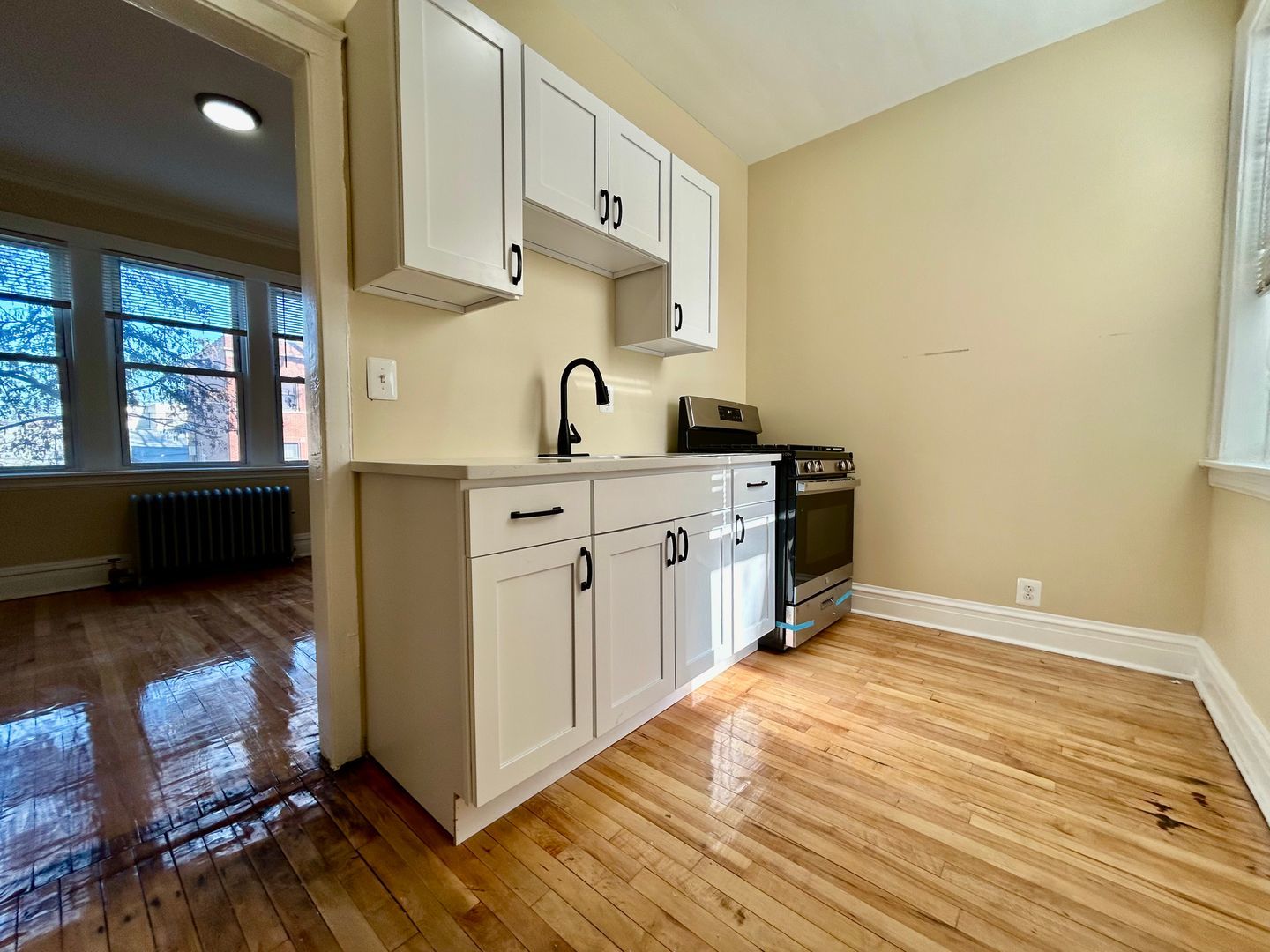 4045 West School Street, Unit 2N Chicago, IL 60641 - Photo 2 of 5 a kitchen with stainless steel appliances a sink and cabinets