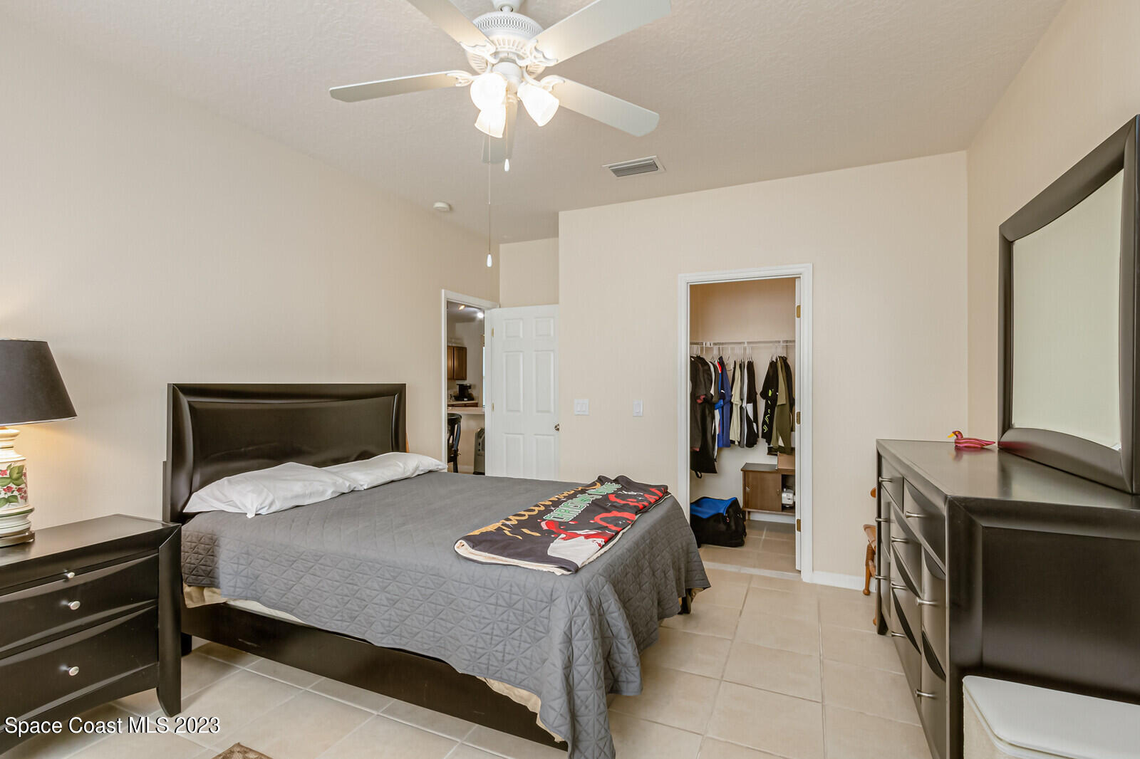 881 Benton Drive Melbourne, FL 32901 - Photo 13 of 34 a bedroom with a bed and a chandelier