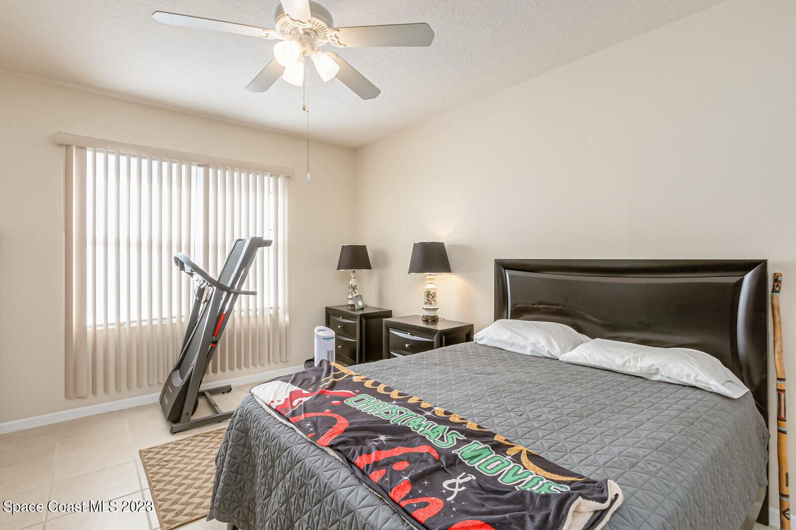 881 Benton Drive Melbourne, FL 32901 - Photo 14 of 34 a bedroom with a bed and glass windows