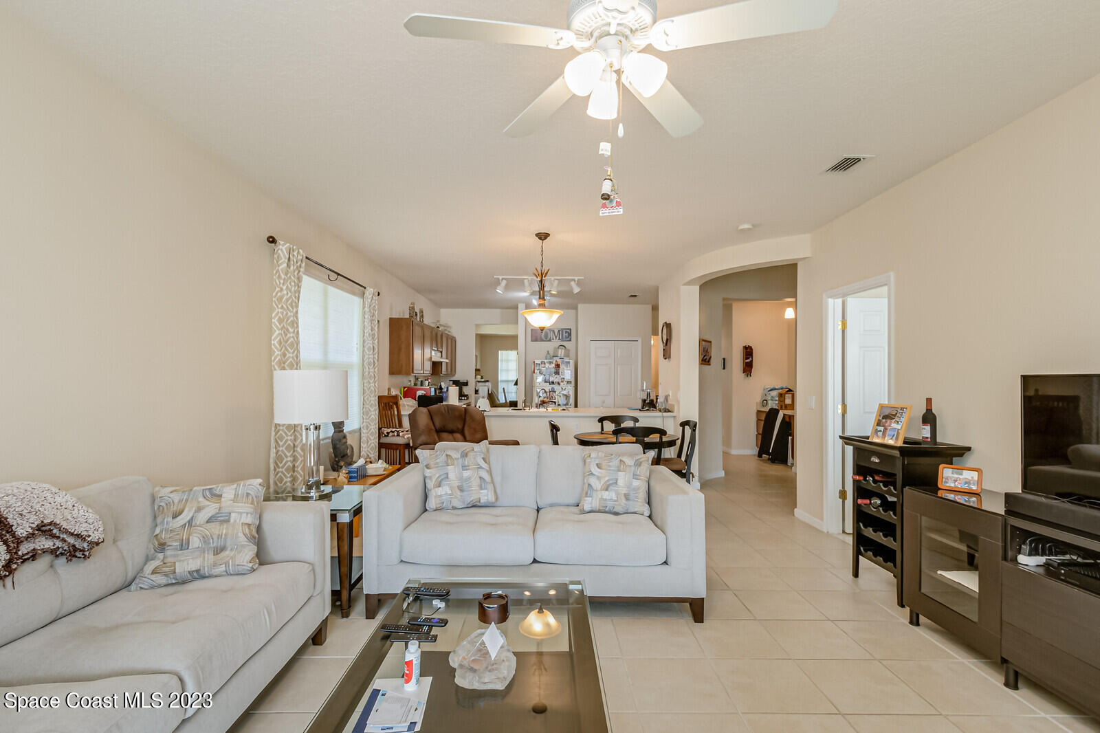 881 Benton Drive Melbourne, FL 32901 - Photo 21 of 34 a living room with furniture and a chandelier
