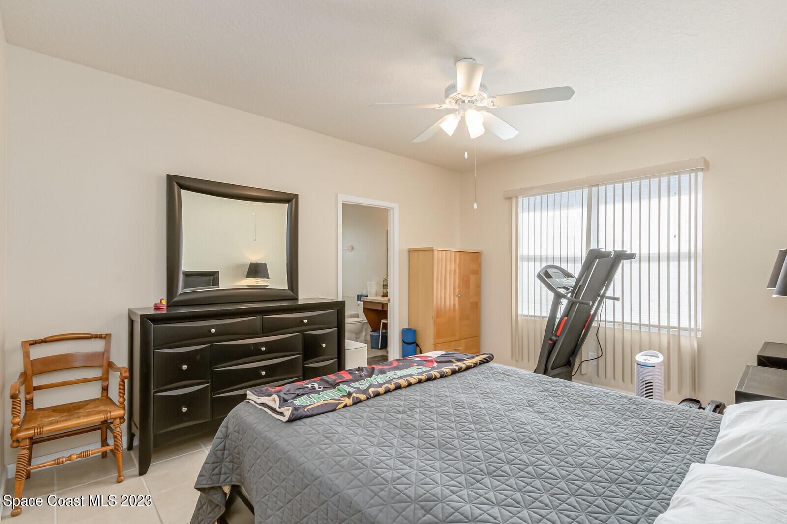 881 Benton Drive Melbourne, FL 32901 - Photo 28 of 34 a bedroom with a bed and a chandelier