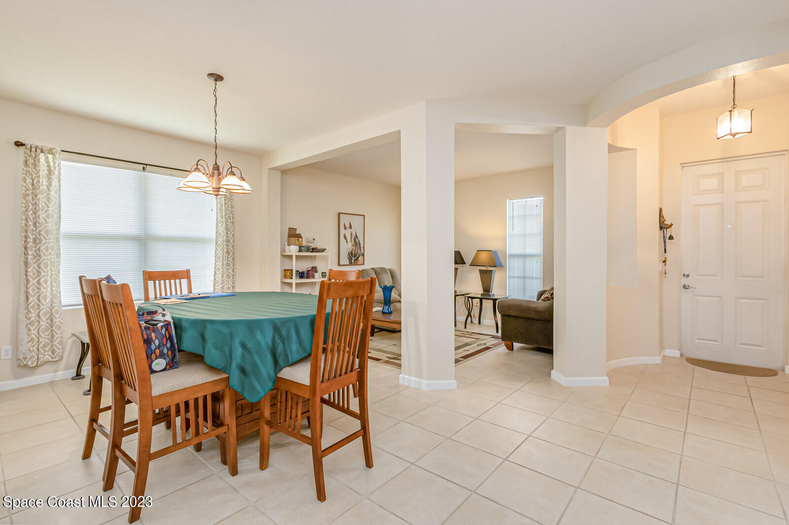 881 Benton Drive Melbourne, FL 32901 - Photo 30 of 34 a view of a dining room with furniture and a chandelier