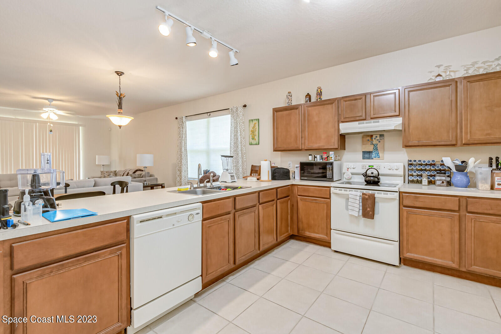 881 Benton Drive Melbourne, FL 32901 - Photo 6 of 34 a kitchen with cabinets appliances and a counter top space