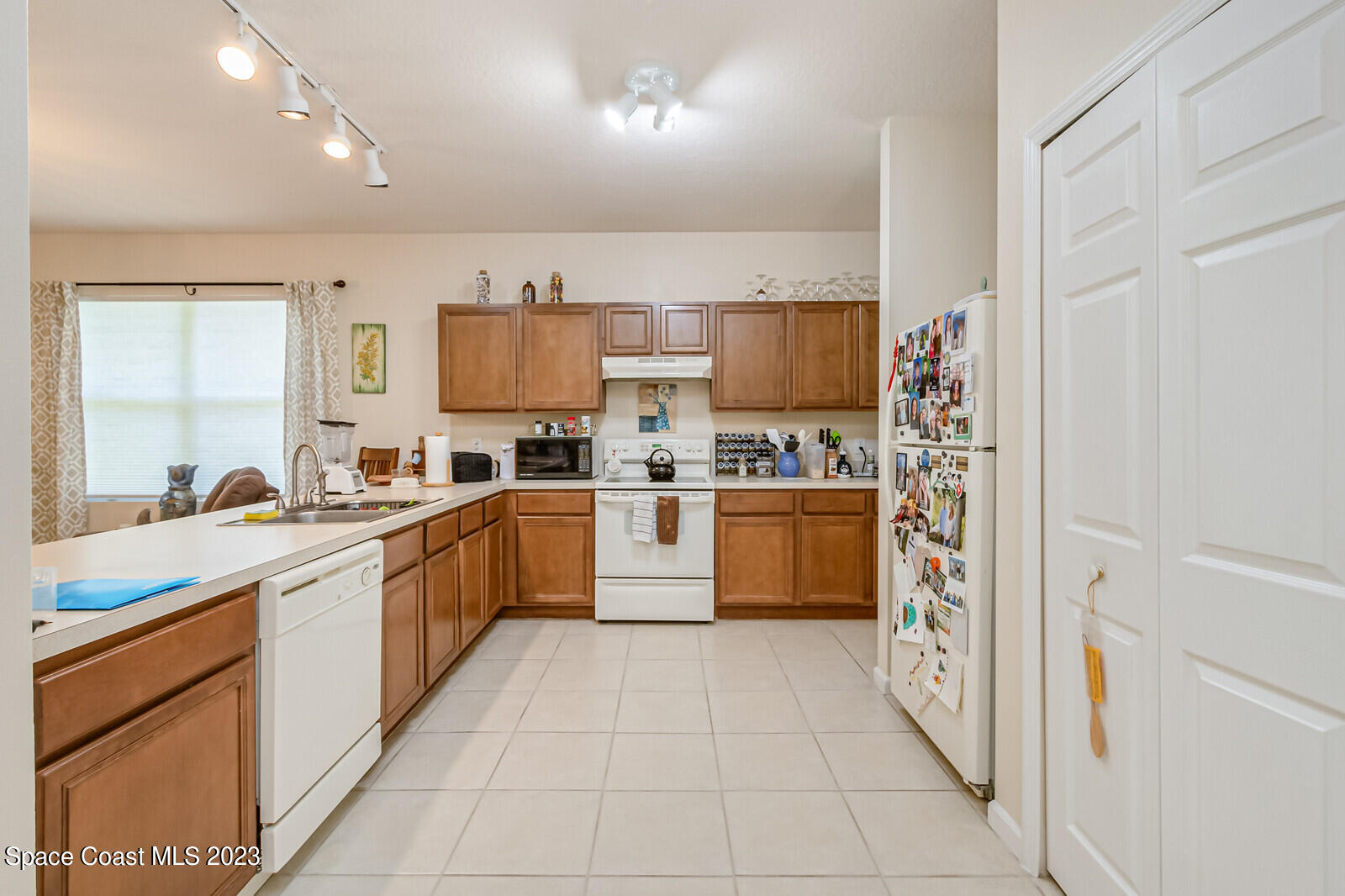 881 Benton Drive Melbourne, FL 32901 - Photo 7 of 34 a kitchen with stainless steel appliances a refrigerator sink and cabinets