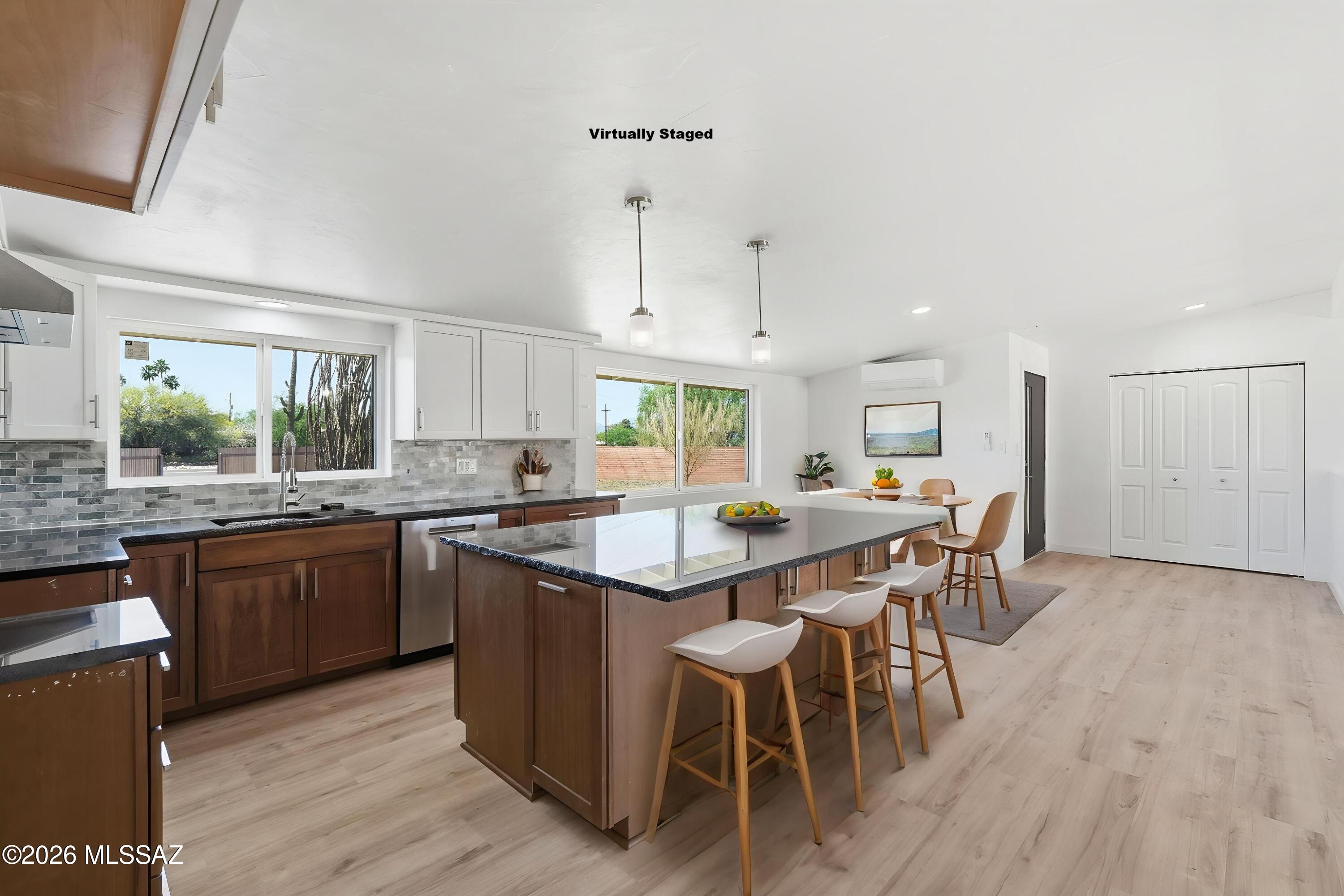 950 West Ina Road Tucson, AZ 85704 - Photo 7 of 54 a kitchen with stainless steel appliances granite countertop a table chairs sink and cabinets